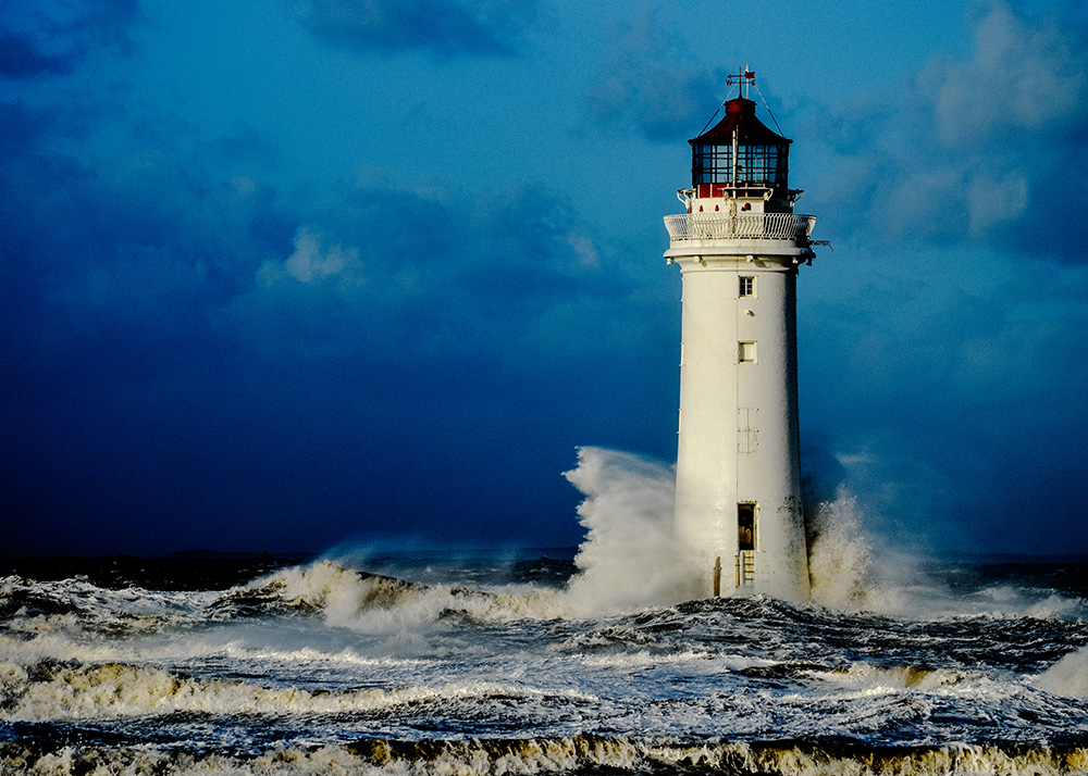 A lighthouse standing strong amidst crashing waves, symbolizing the resilience and stability of community exchange.